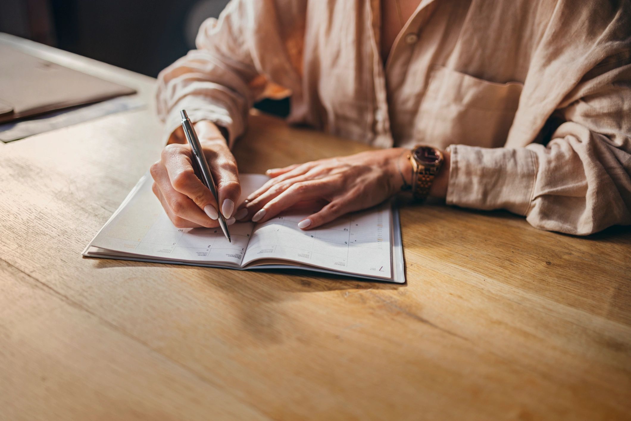 Person writing in a journal to reflect on personal growth