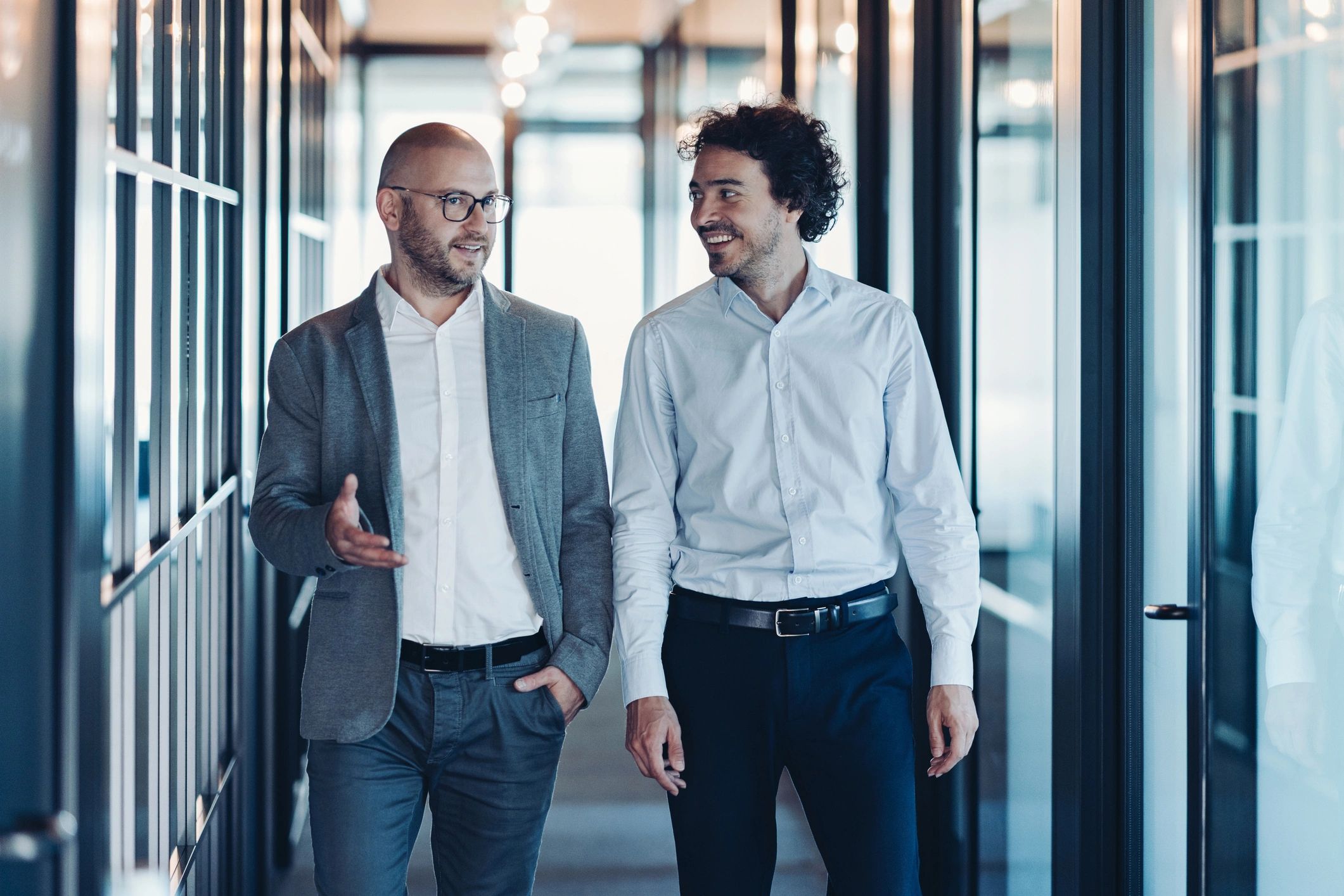 Two professionals in conversation while moving forward together