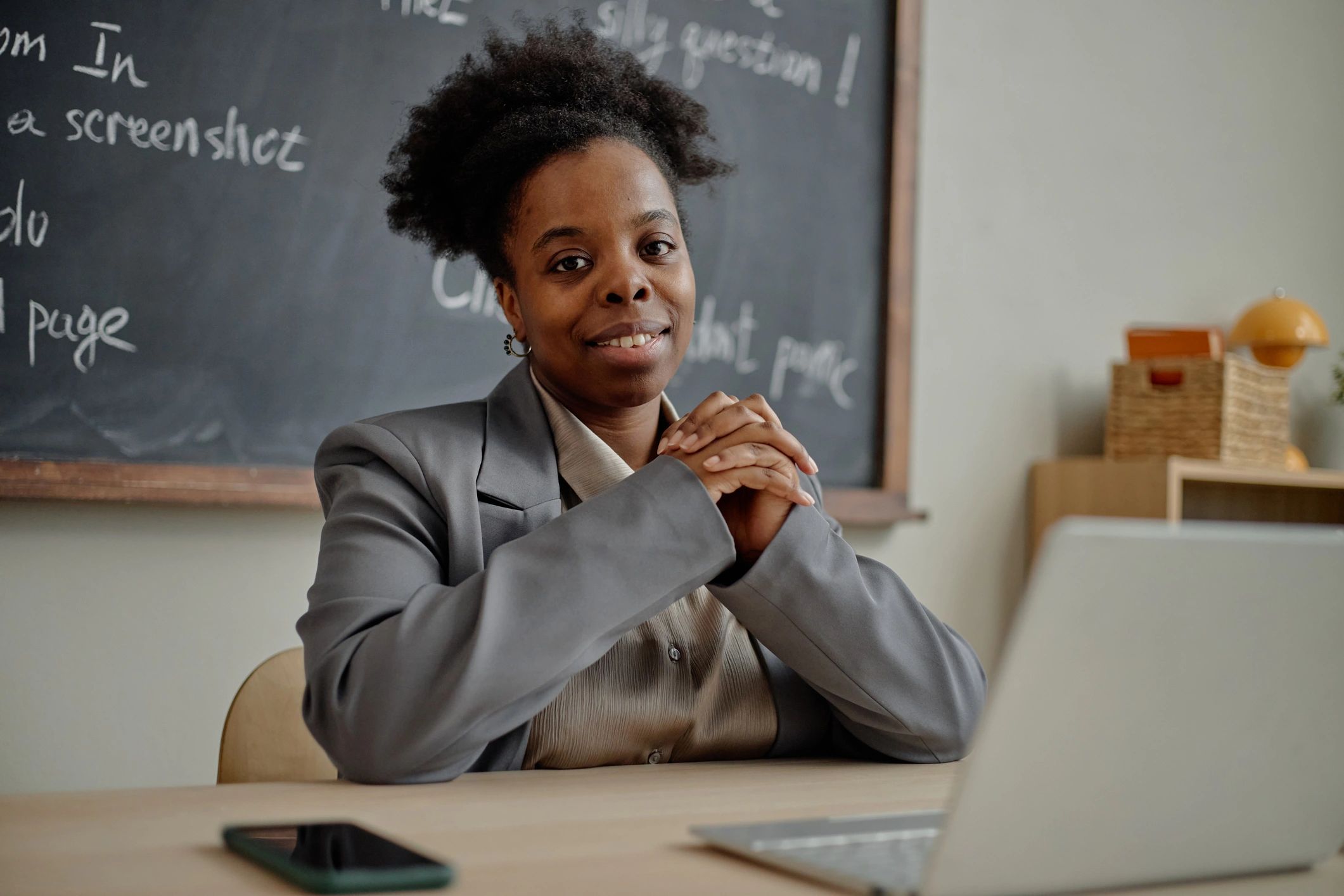 Woman seated with laptop representing accessible coaching membership