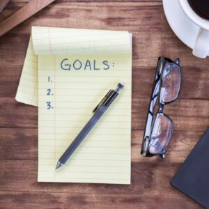 Note pad titled ""goals"" and other belongings